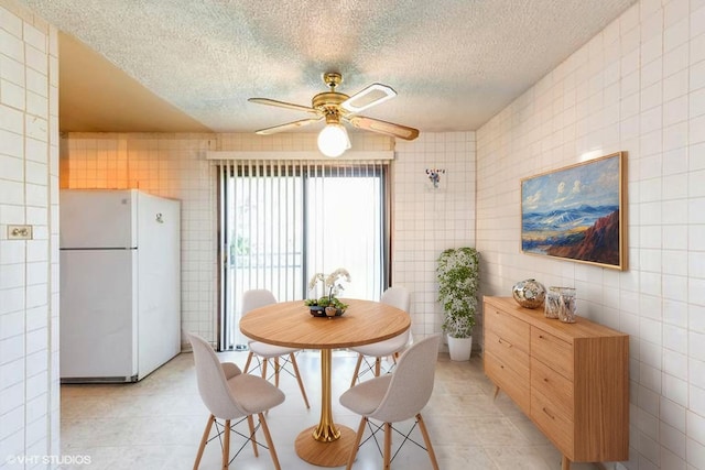 18111 Orleans Dr, Hazel Crest, IL 60429 - dining space featuring tile walls, a textured ceiling, ceiling fan, and light tile patterned flooring