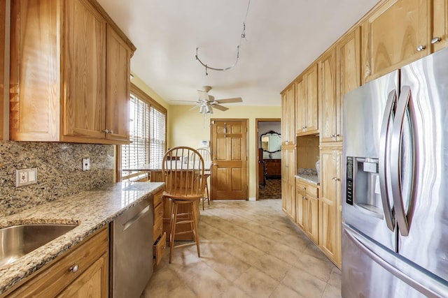 1021 S Blvd, Evanston, IL 60202 - kitchen featuring stainless steel appliances, backsplash, light stone counters, and a ceiling fan