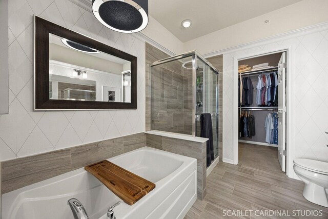 4404 Monroe Ct, Naperville, IL 60564 - bathroom with a stall shower, a garden tub, a walk in closet, toilet, and tile walls