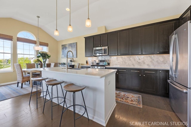 4404 Monroe Ct, Naperville, IL 60564 - kitchen with appliances with stainless steel finishes, vaulted ceiling, dark wood-style floors, backsplash, and a breakfast bar area
