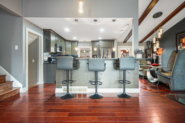 8909 S 85th Ct, Hickory Hills, IL 60457 - kitchen featuring stainless steel appliances, dark wood-type flooring, a breakfast bar area, and pendant lighting