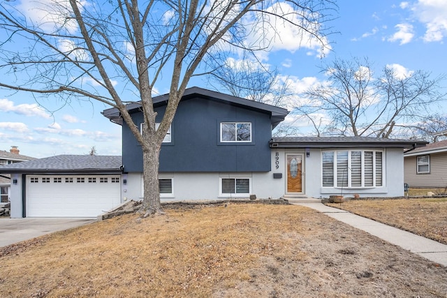 8909 S 85th Ct, Hickory Hills, IL 60457 - split level home featuring a garage, stucco siding, driveway, and entry steps