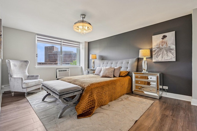 40 N Tower Rd Unit 3G, Oak Brook, IL 60523 - bedroom featuring wood finished floors, a baseboard heating unit, a wall unit AC, and baseboards