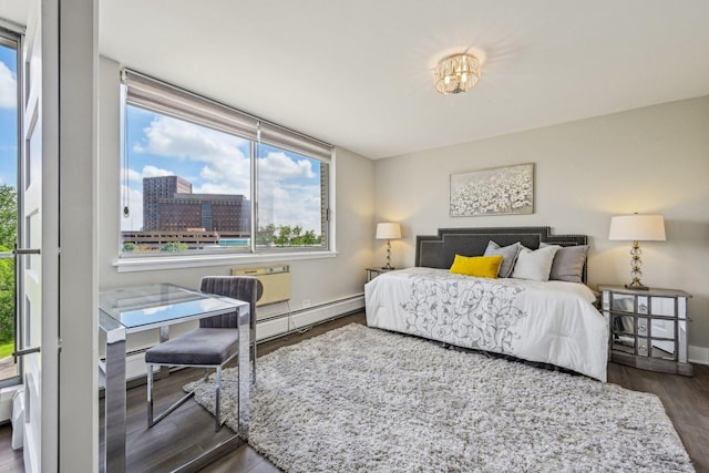 40 N Tower Rd Unit 3G, Oak Brook, IL 60523 - bedroom with a baseboard heating unit, multiple windows, dark wood finished floors, and baseboards