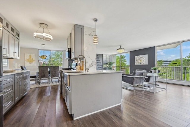 40 N Tower Rd Unit 3G, Oak Brook, IL 60523 - kitchen with gray cabinets, dark wood-style flooring, light countertops, and healthy amount of natural light