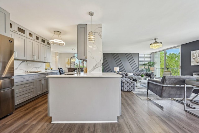 40 N Tower Rd Unit 3G, Oak Brook, IL 60523 - kitchen with gray cabinetry, freestanding refrigerator, open floor plan, dark wood-style floors, and glass insert cabinets