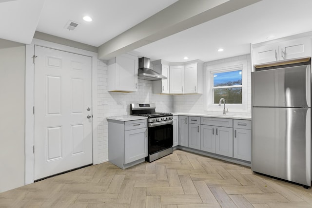 1315 S Kolin Ave, Chicago, IL 60623 - kitchen with stainless steel appliances, wall chimney exhaust hood, a sink, gray cabinets, and backsplash