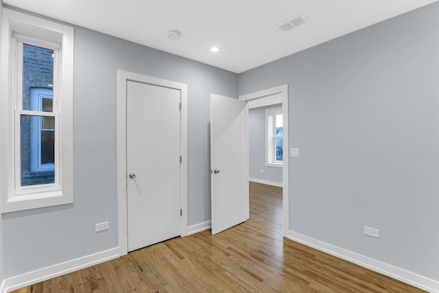 1315 S Kolin Ave, Chicago, IL 60623 - unfurnished bedroom with baseboards, wood finished floors, and recessed lighting