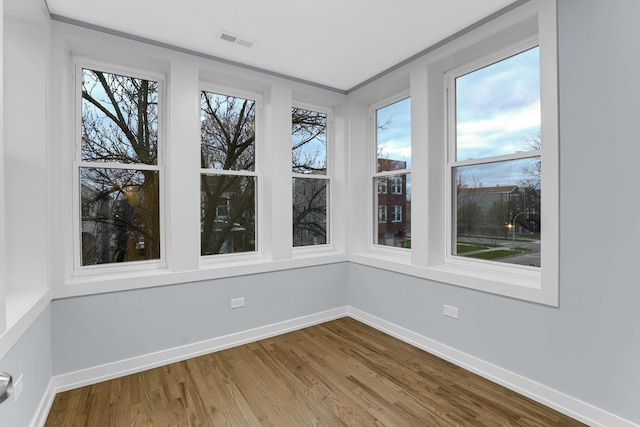 1315 S Kolin Ave, Chicago, IL 60623 - unfurnished sunroom featuring wood finished floors and baseboards