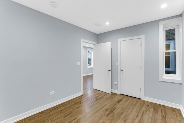 1315 S Kolin Ave, Chicago, IL 60623 - unfurnished bedroom featuring wood finished floors, baseboards, and recessed lighting