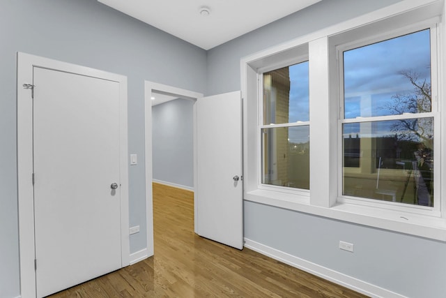 1315 S Kolin Ave, Chicago, IL 60623 - spare room featuring baseboards and wood finished floors