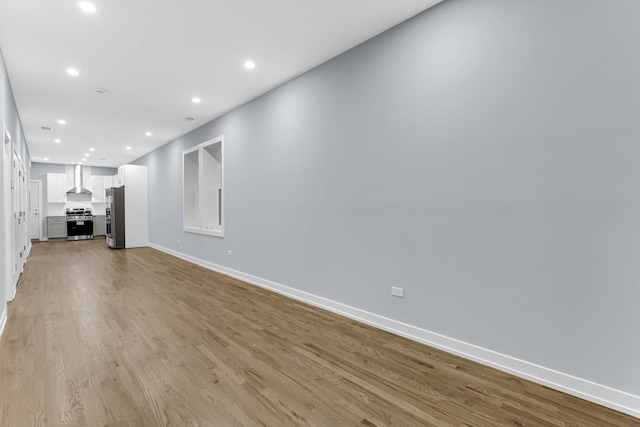 1315 S Kolin Ave, Chicago, IL 60623 - unfurnished living room featuring baseboards, recessed lighting, and light wood-style floors