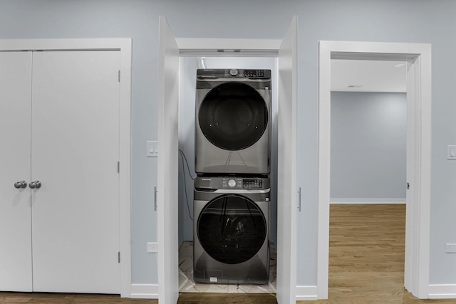 1315 S Kolin Ave, Chicago, IL 60623 - laundry room with stacked washer / dryer, wood finished floors, and baseboards