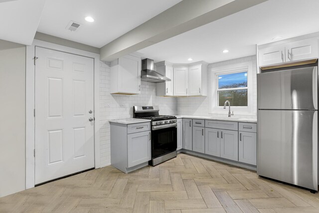 1315 S Kolin Ave, Chicago, IL 60623 - kitchen featuring stainless steel appliances, wall chimney range hood, a sink, gray cabinets, and backsplash