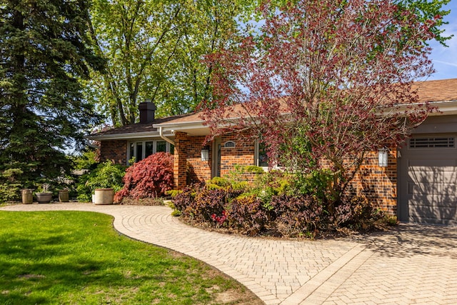 15322 Woodmar Dr, Orland Park, IL 60462 - view of front of house with brick siding, an attached garage, decorative driveway, a chimney, and a front yard