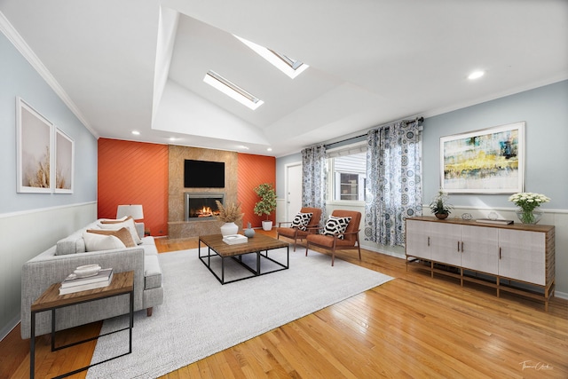 15322 Woodmar Dr, Orland Park, IL 60462 - living area featuring wood finished floors, a tiled fireplace, recessed lighting, a skylight, and an accent wall