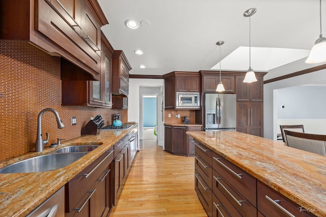 15322 Woodmar Dr, Orland Park, IL 60462 - kitchen featuring appliances with stainless steel finishes, a sink, light wood-style flooring, tasteful backsplash, and light stone countertops