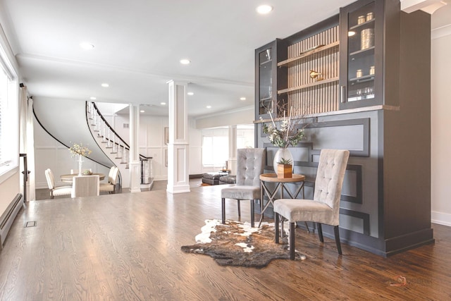 sitting room with decorative columns, stairway, wood finished floors, baseboards, and recessed lighting