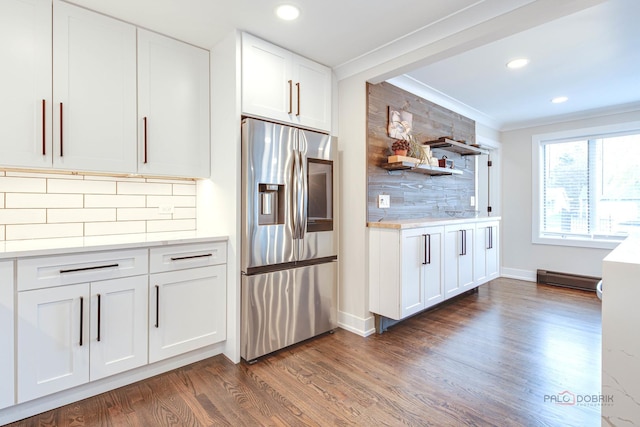 kitchen featuring stainless steel fridge with ice dispenser, crown molding, dark wood-style flooring, tasteful backsplash, and light countertops