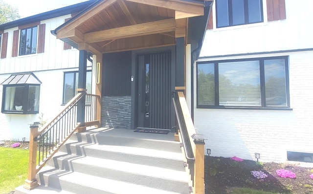 view of exterior entry featuring brick siding