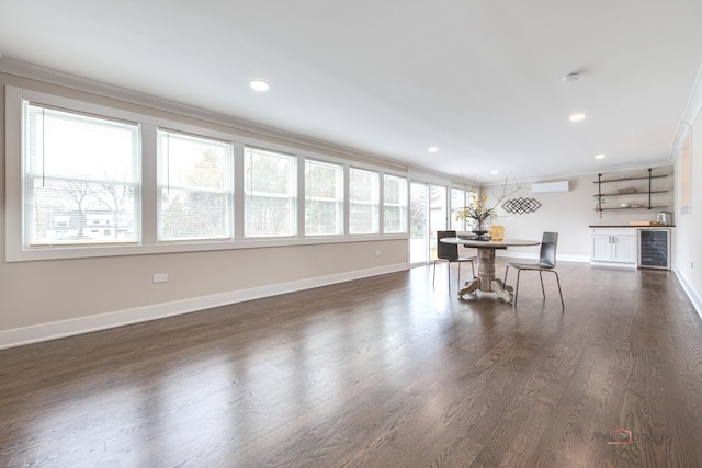 dining space with beverage cooler, crown molding, baseboards, a wall mounted air conditioner, and dark wood-type flooring
