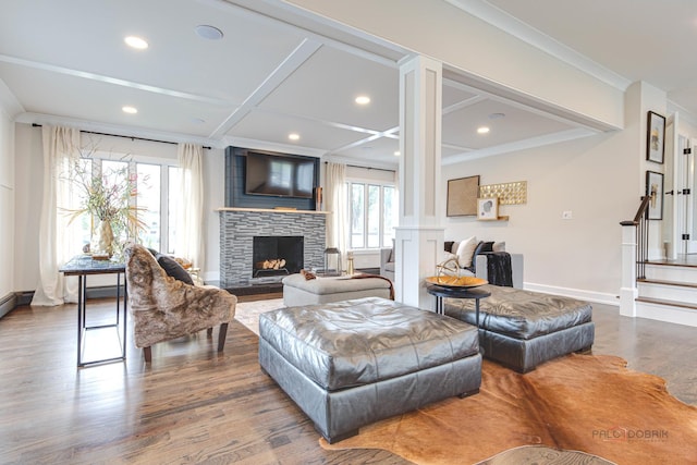 living room with wood finished floors, a fireplace, recessed lighting, ornamental molding, and baseboards