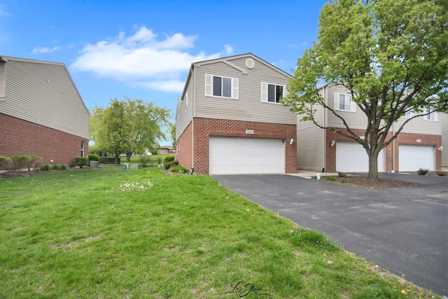 16560 Willow Walk Dr, Lockport, IL 60441 - view of front of house with an attached garage, brick siding, a front yard, and asphalt driveway