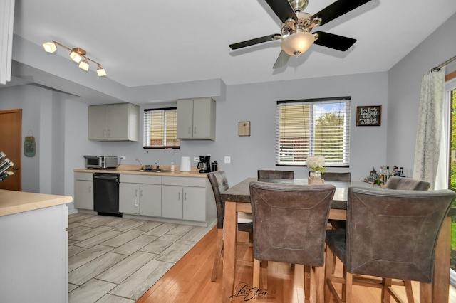 16560 Willow Walk Dr, Lockport, IL 60441 - kitchen featuring black dishwasher, a ceiling fan, a sink, stainless steel microwave, and light countertops