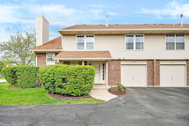 8530 Westberry Ln, Tinley Park, IL 60487 - view of front of home featuring driveway, brick siding, a chimney, an attached garage, and roof with shingles