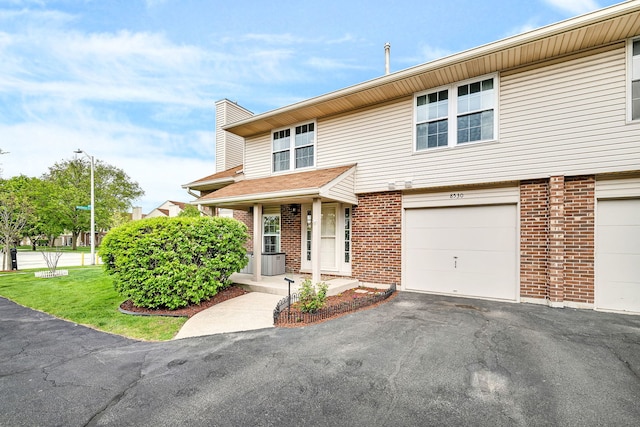 8530 Westberry Ln, Tinley Park, IL 60487 - multi unit property with brick siding, a chimney, a garage, and driveway