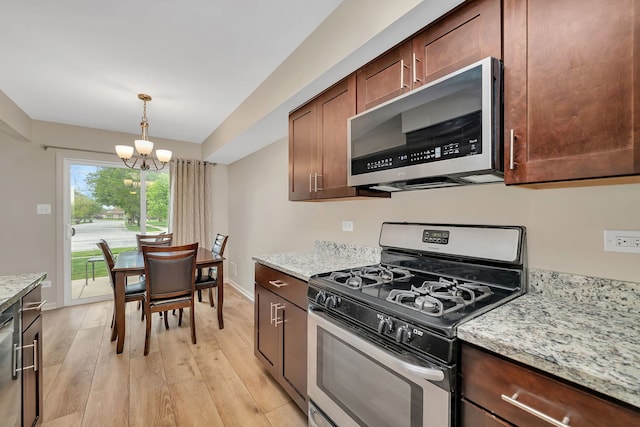8530 Westberry Ln, Tinley Park, IL 60487 - kitchen with stainless steel appliances, a chandelier, light wood finished floors, and light stone countertops