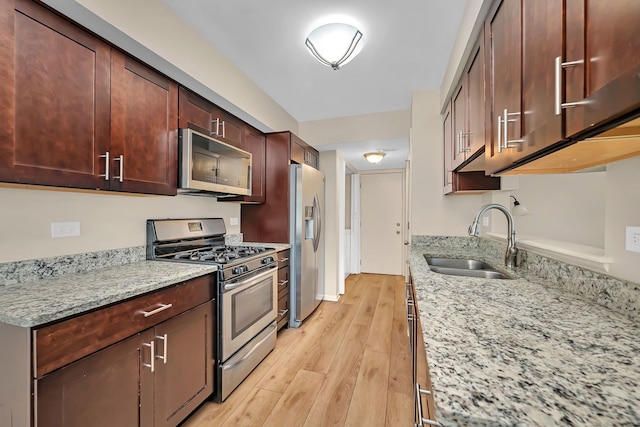 8530 Westberry Ln, Tinley Park, IL 60487 - kitchen featuring stainless steel appliances, a sink, light wood finished floors, and light stone countertops