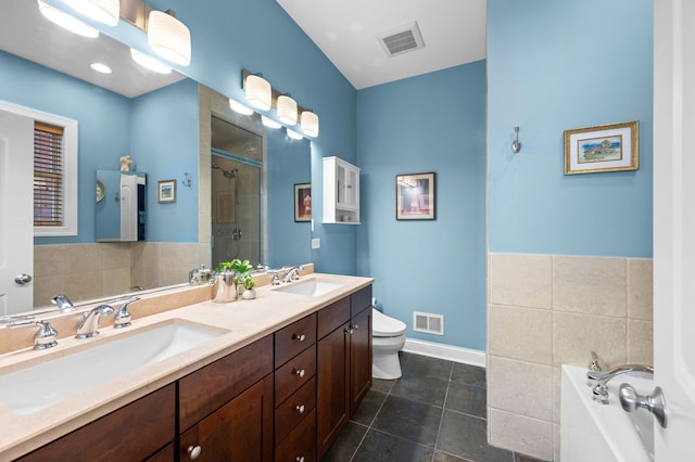 6036 N Damen Ave Unit 1S, Chicago, IL 60659 - bathroom with a shower stall, double vanity, a garden tub, toilet, and tile patterned flooring