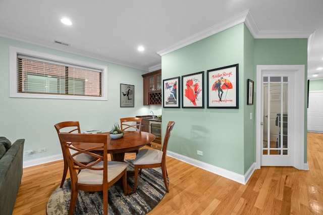 6036 N Damen Ave Unit 1S, Chicago, IL 60659 - dining room featuring ornamental molding, light wood-type flooring, baseboards, recessed lighting, and wine cooler