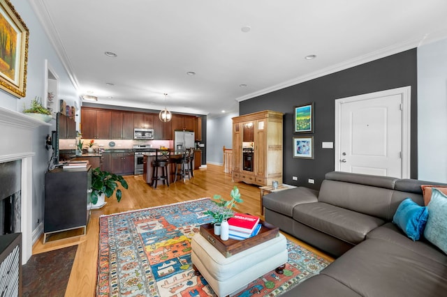 6036 N Damen Ave Unit 1S, Chicago, IL 60659 - living room featuring ornamental molding, light wood finished floors, recessed lighting, baseboards, and a premium fireplace