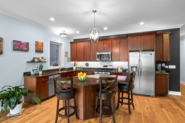 6036 N Damen Ave Unit 1S, Chicago, IL 60659 - kitchen with stainless steel appliances, crown molding, tasteful backsplash, a sink, and a kitchen bar