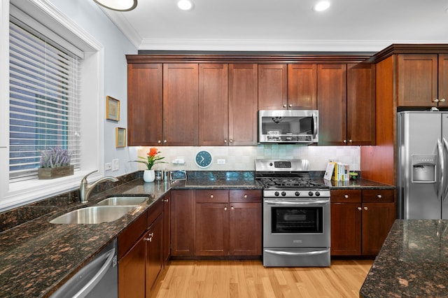 6036 N Damen Ave Unit 1S, Chicago, IL 60659 - kitchen featuring stainless steel appliances, a sink, light wood-style flooring, crown molding, and backsplash