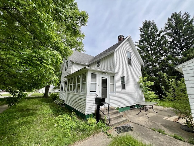 866 E Center St, Paxton, IL 60957 - view of front of house with a chimney, a shingled roof, and entry steps