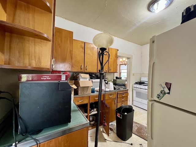 866 E Center St, Paxton, IL 60957 - kitchen featuring white appliances and brown cabinetry