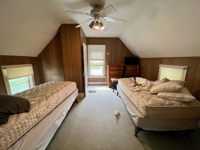 866 E Center St, Paxton, IL 60957 - bedroom featuring lofted ceiling, wooden walls, light colored carpet, and ceiling fan