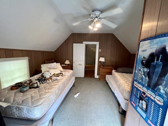 866 E Center St, Paxton, IL 60957 - bedroom with vaulted ceiling, light colored carpet, wood walls, and ceiling fan
