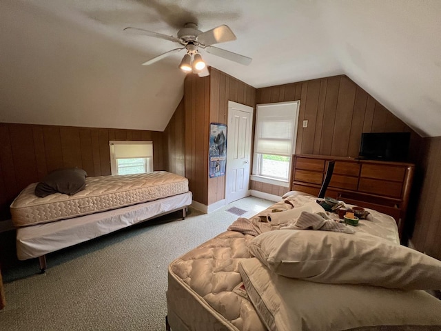 866 E Center St, Paxton, IL 60957 - bedroom with vaulted ceiling, wooden walls, multiple windows, light carpet, and a ceiling fan