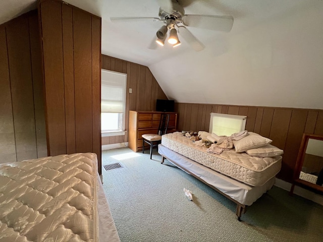 866 E Center St, Paxton, IL 60957 - bedroom with wood walls, light colored carpet, lofted ceiling, and a ceiling fan