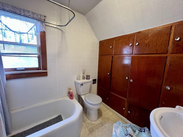 866 E Center St, Paxton, IL 60957 - bathroom featuring a tub to relax in, tile walls, toilet, tile patterned floors, and lofted ceiling