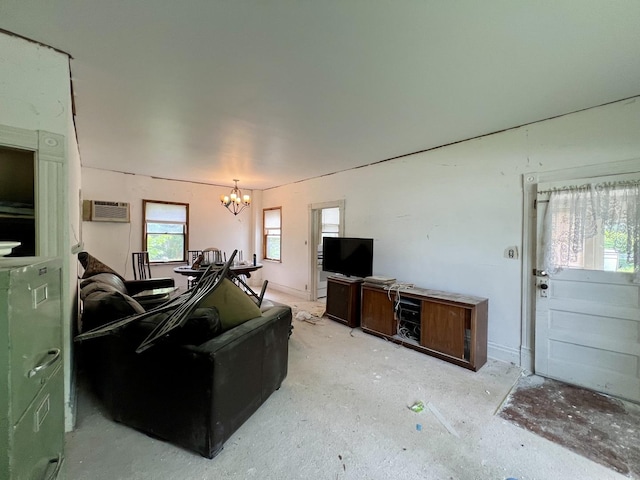 866 E Center St, Paxton, IL 60957 - living area with a chandelier, an AC wall unit, and concrete floors