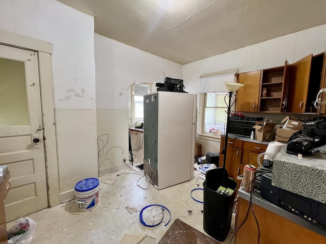 866 E Center St, Paxton, IL 60957 - kitchen featuring freestanding refrigerator, open shelves, and brown cabinets