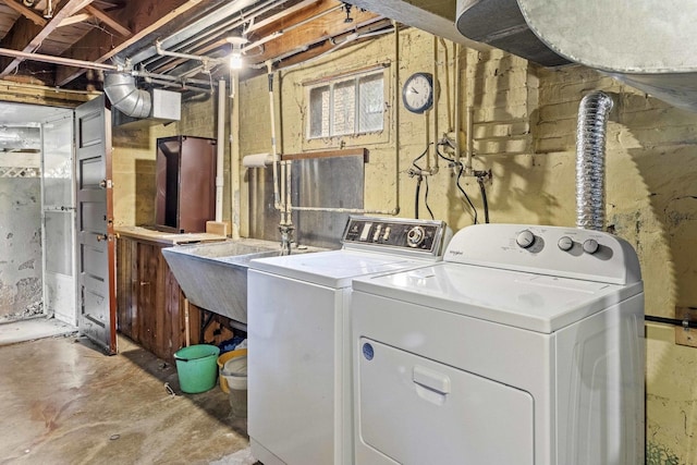 clothes washing area with washing machine and dryer
