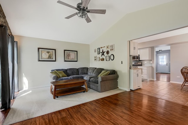 3025 Diane Dr, Aurora, IL 60504 - living room with ceiling fan, wood finished floors, baseboards, and high vaulted ceiling