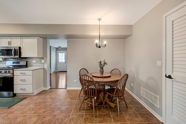 3025 Diane Dr, Aurora, IL 60504 - dining space with tile patterned flooring, a chandelier, and baseboards