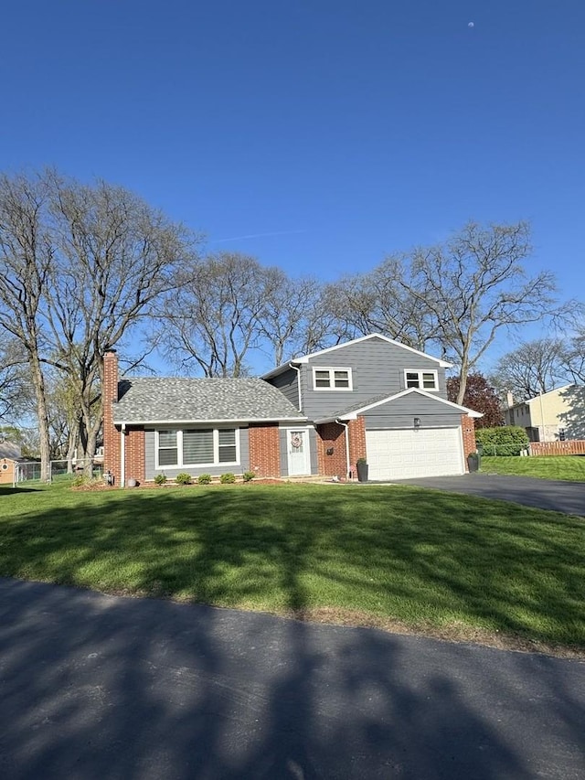 8 W Emerson St, Arlington Heights, IL 60005 - view of front facade with asphalt driveway, brick siding, a chimney, a front lawn, and a garage